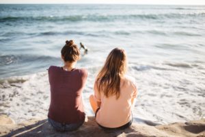 Friends sitting by the beach